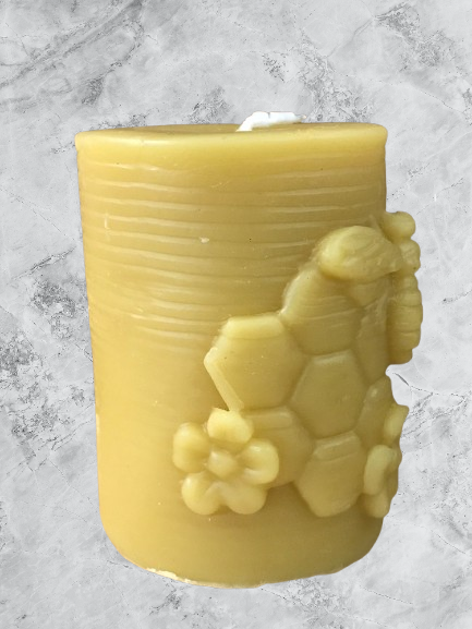 Pillar candle mold with bee, comb, and flowers