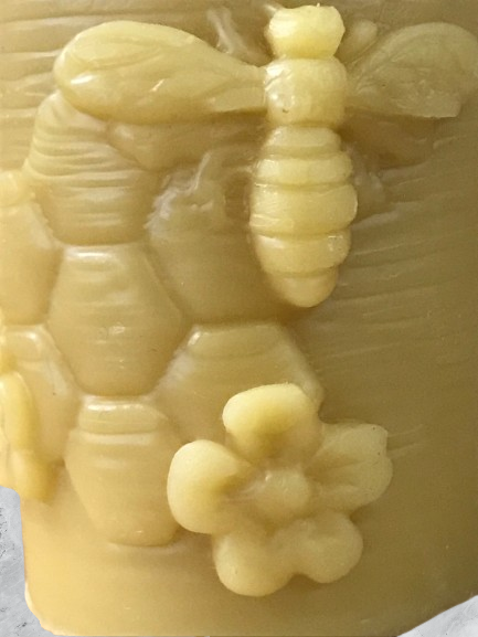 Candle-votive with flowers and a bee